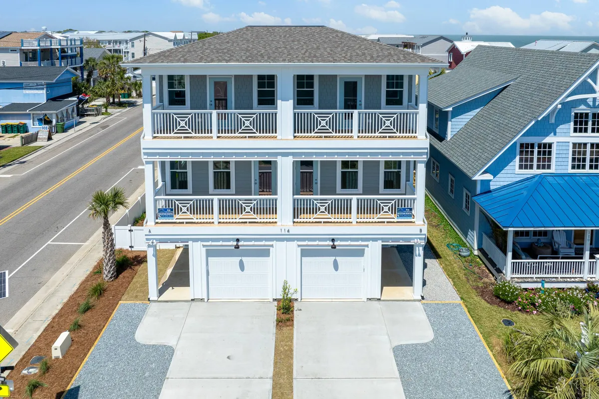 The exterior of a three-story house with multiple balconies, a palm tree, and a broad driveway providing ample parking. The scene is cheerful and welcoming, ideal for family gatherings, group arrivals, and stress-free parking.